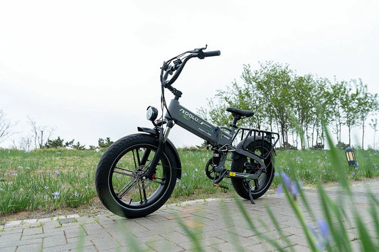 KOOLUX compact folding fat tire electric bike, front headlight, outdoor park sidewalk, adult recreational electric bicycle