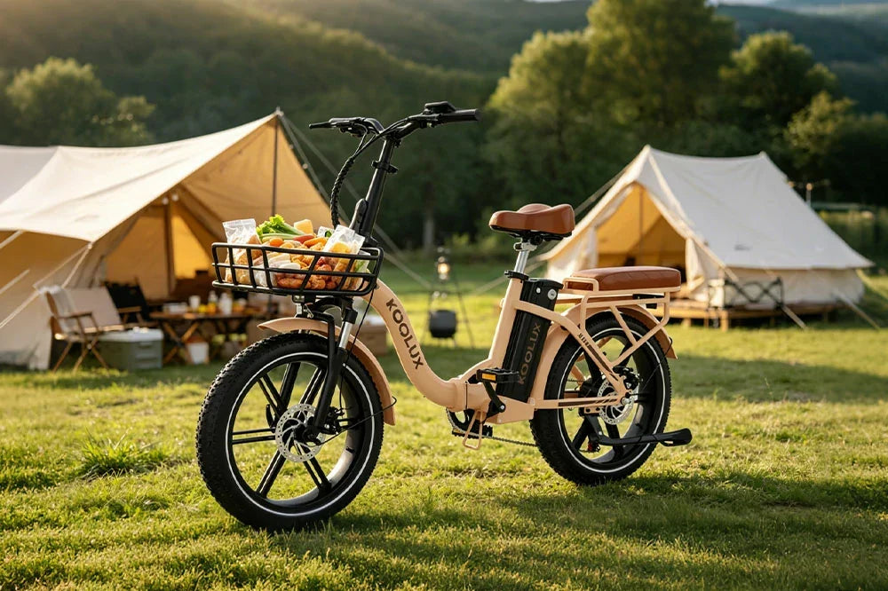 KOOLUX step-through folding electric bike with front grocery basket parked at outdoor glamping campsite